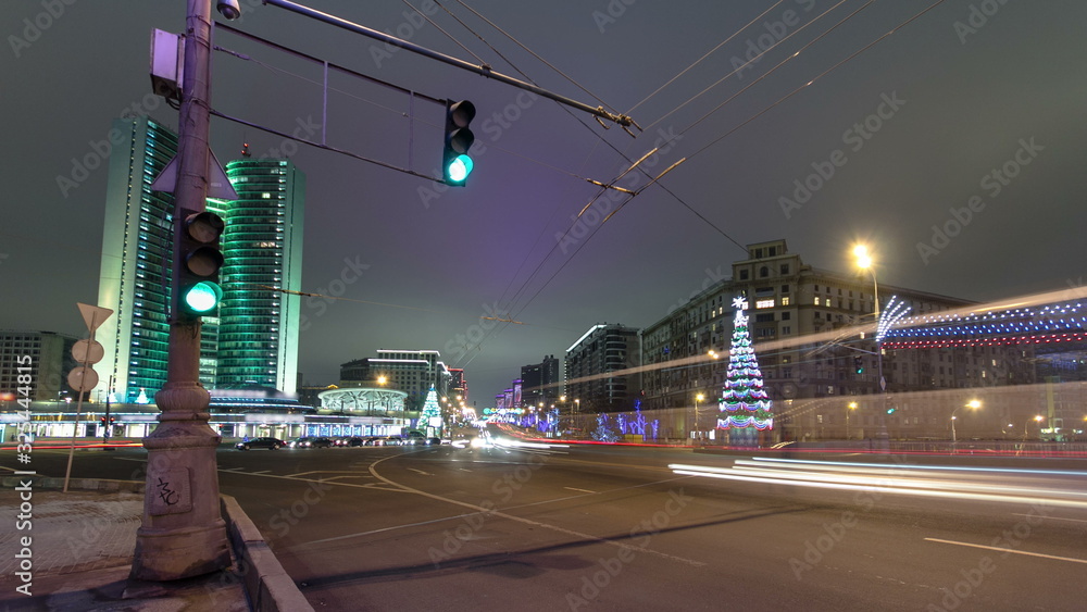 Fototapeta premium Buildings at New Arbat Street winter night timelapse. New Arbat is located in the central part of Moscow