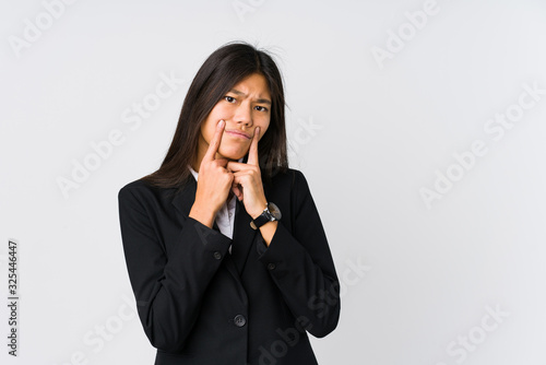 Young asian business woman doubting between two options.