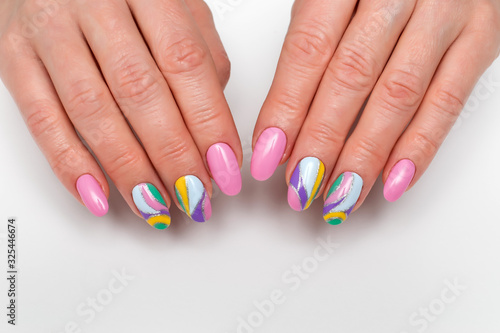 Summer color manicure. pink  lilac  white  yellow  silver manicure on long oval nails on white photo close up