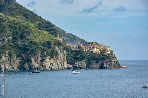 Manarola as seen from Corniglia from a distance with a few boats
