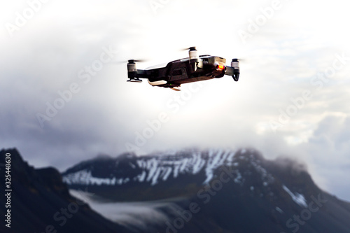 Image of a drone flying over the iceland snowy mountains