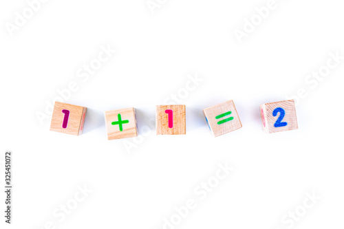 Kids toys wooden cubs with letters and numbers on white background