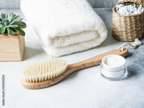 Various items for the care of women's skin in the bathroom on grey background.
