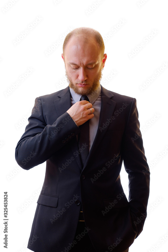Businessman in black suit straightens his jacket and tie. Young man large company manager to prepare for an important meeting for the conclusion of the contract. Businessman in black suit straightens his jacket and tie. Young man large company manager to prepare for an important meeting for the conclusion of the contract.