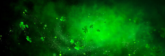 St. Patrick's Day abstract green background decorated with shamrock leaves. Patrick Day pub party celebrating. Abstract Border art design magic backdrop. Widescreen clovers on black with copy space.