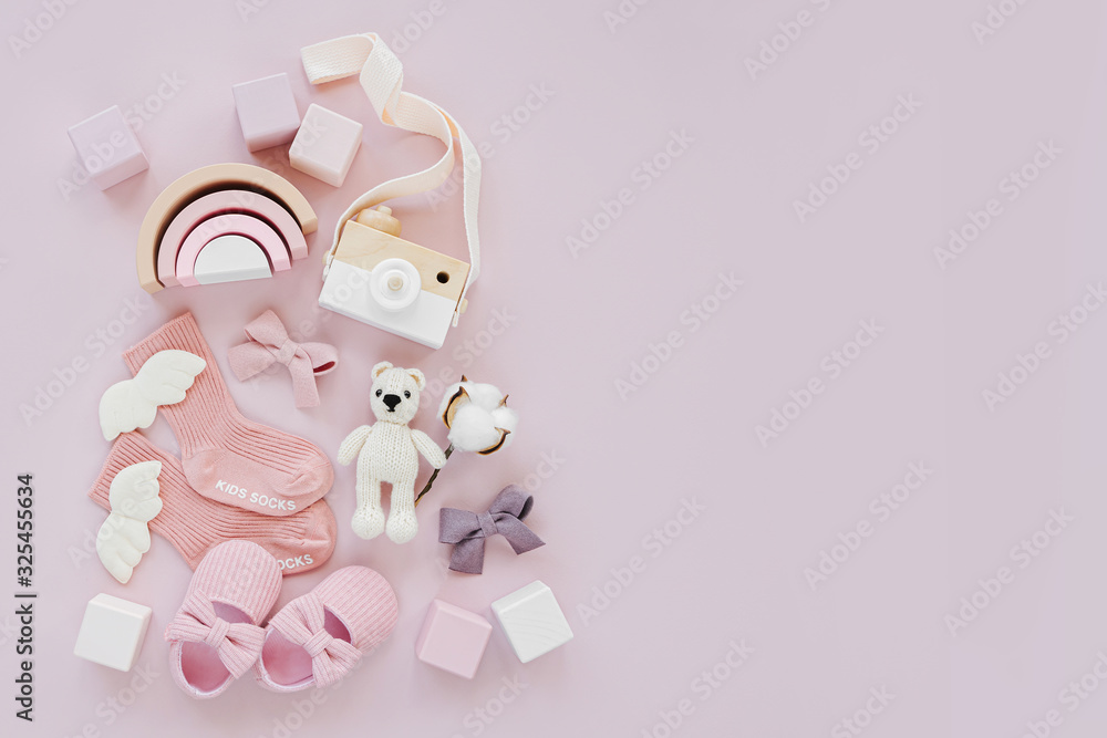 Set of baby stuff and accessories for girl on pastel background. Pink socks, shoes and toys. Baby shower concept. Fashion newborn. Flat lay, top view Set of baby stuff and accessories for girl on pastel background. Pink socks, shoes and toys. Baby shower concept. Fashion newborn. Flat lay, top view