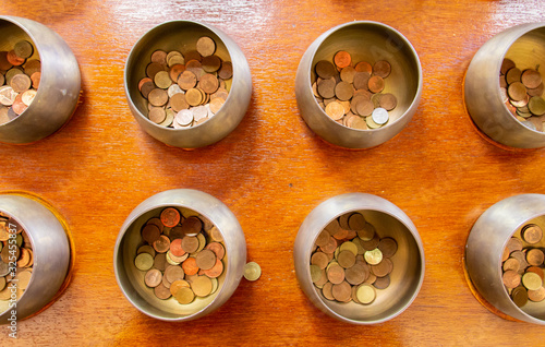 Coin in Monk's alms bowl at Phra Prathom Chedi of Nakon Pathom photo