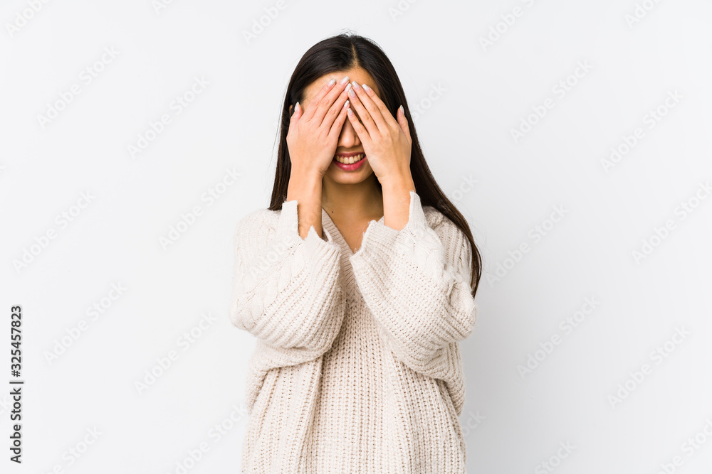 Young chinese woman isolated covers eyes with hands, smiles broadly waiting for a surprise. Young chinese woman isolated covers eyes with hands, smiles broadly waiting for a surprise.