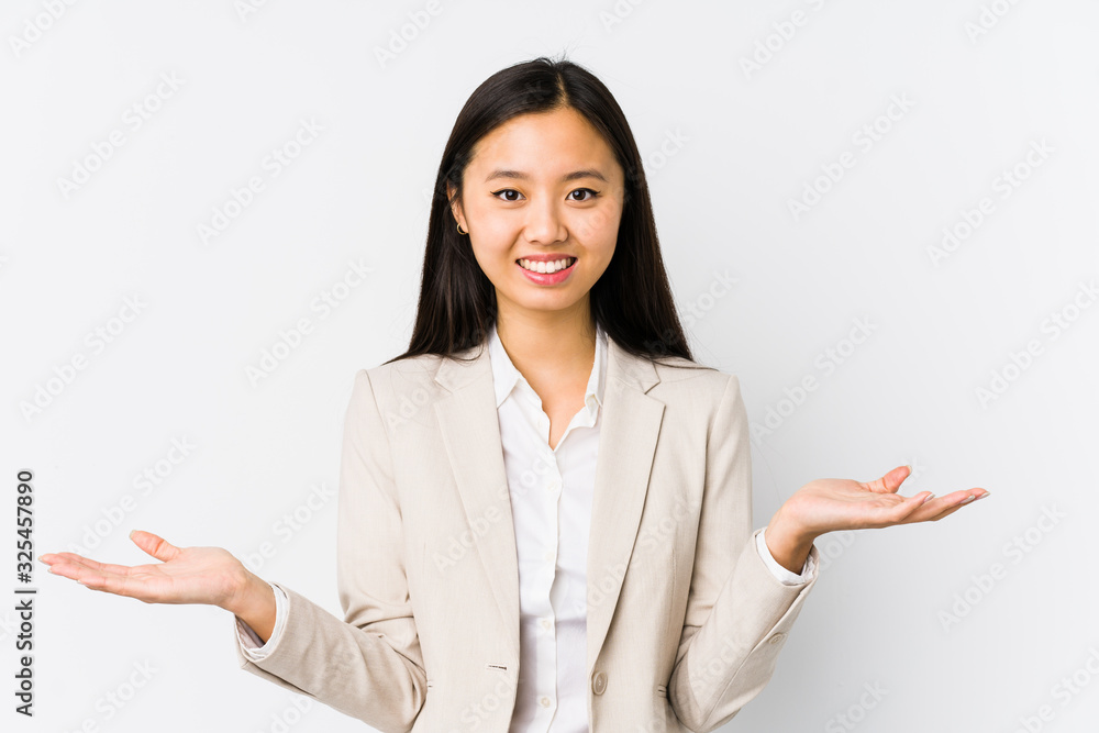 Young chinese business woman isolated showing a welcome expression. Young chinese business woman isolated showing a welcome expression.