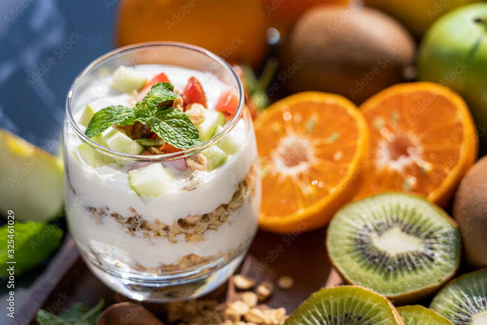 Plain yogurt with fresh fruits and granola on top in glass.Healthy food Plain yogurt with fresh fruits and granola on top in glass.Healthy food
