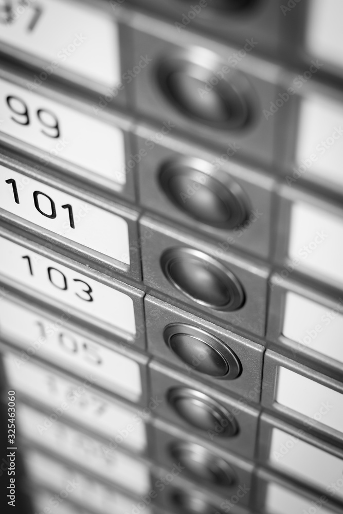 Row of doorbells, in oblique perspective, of an apartment complex in black and white. Row of doorbells, in oblique perspective, of an apartment complex in black and white.