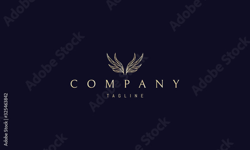 Vector golden logo on which an abstract image of wings in the form of leaves.