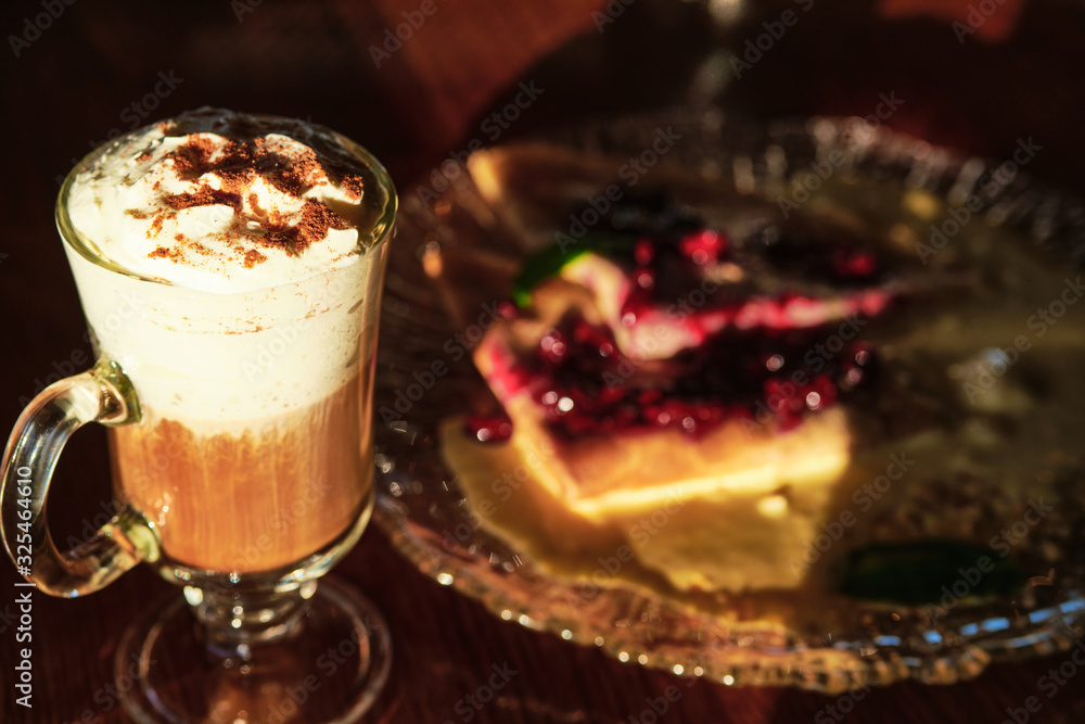 cappuccino coffee with two pancakes with berrie jam and cream on a glass plate on a wood table cappuccino coffee with two pancakes with berrie jam and cream on a glass plate on a wood table