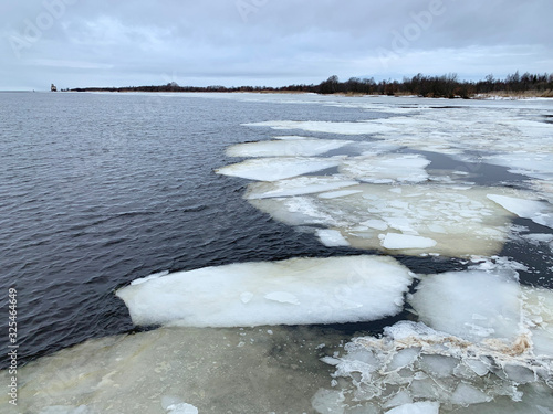 The ice drift on the Sheksna river is abnormally warm in the winter of 2020. Russia, Vologda region photo