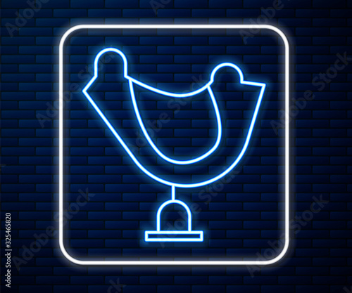 Glowing neon line Wild west saddle icon isolated on brick wall background.  Vector Illustration