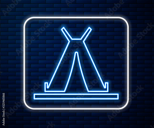 Glowing neon line Traditional indian teepee or wigwam icon isolated on brick wall background. Indian tent.  Vector Illustration