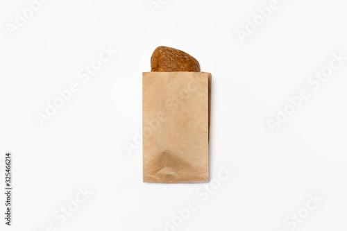 Fresh Black Bread in a brown kraft Paper Bag Mockup on white background.High resolution photo. photo