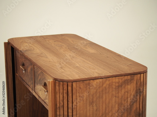 Original designer chest of drawers made of natural wood in its entirety, as well as its details on a white background, from different angles.