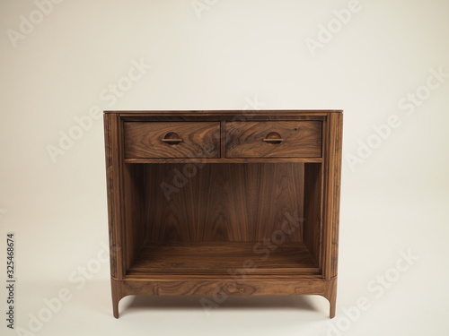 Original designer chest of drawers made of natural wood in its entirety, as well as its details on a white background, from different angles.