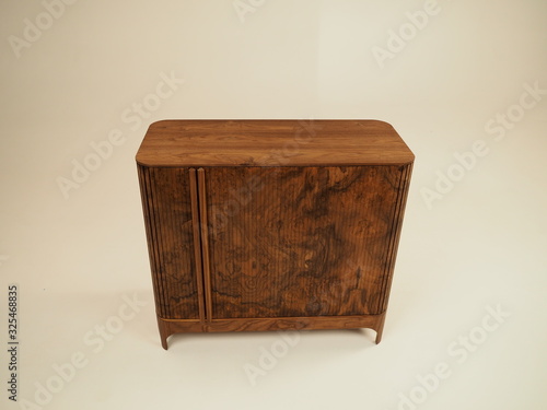 Original designer chest of drawers made of natural wood in its entirety, as well as its details on a white background, from different angles.
