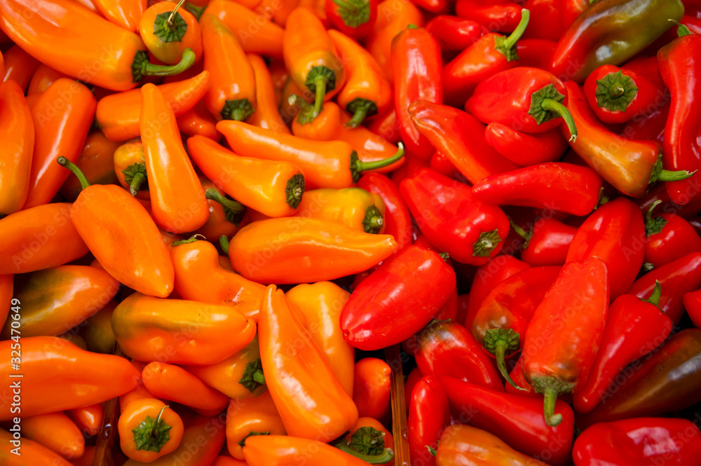Background of closeup red and orange  peppers