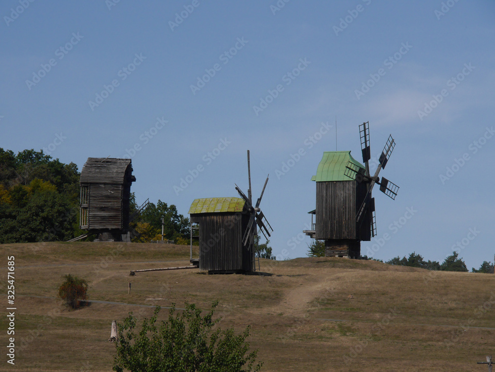 Old windmill. Ukrainian mill of the nineteenth century. Typical rural architecture. Summer outdoor landscape. Village Pirogovo.