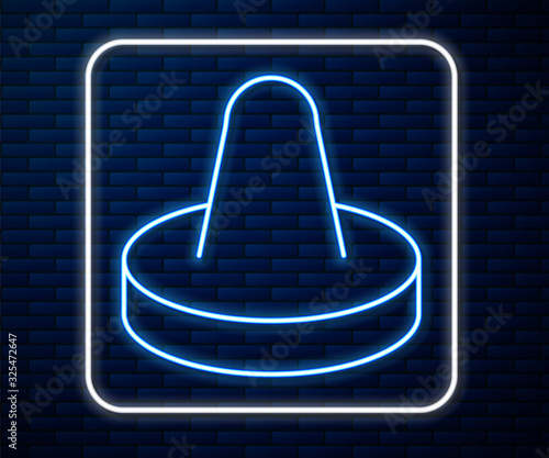 Glowing neon line Mallet and puck for playing air hockey game icon isolated on brick wall background.  Vector Illustration