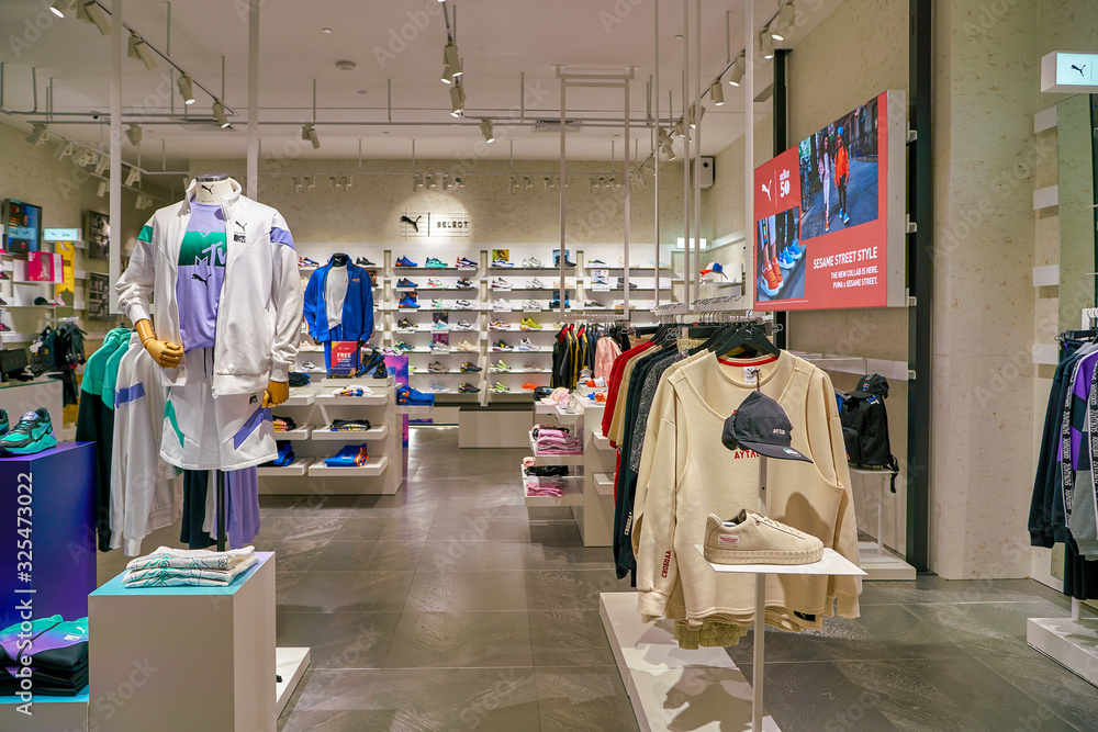 SINGAPORE - CIRCA APRIL, 2019: clothes and footwear on display at Puma  Select store in the Shoppes at Marina Bay Sands. Stock Photo | Adobe Stock