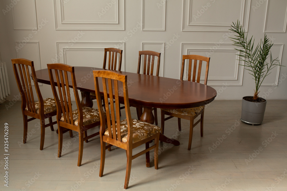A classic set of wooden furniture for the kitchen. A set of chairs to the table in a classic interior A classic set of wooden furniture for the kitchen. A set of chairs to the table in a classic interior