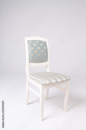 Single white chair with a soft striped seat on an isolated white background