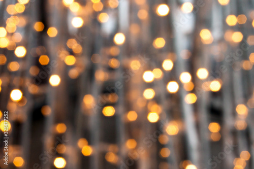 Abstract bokeh background. Golden circles of lights bulb festive garland blurred defocused shine