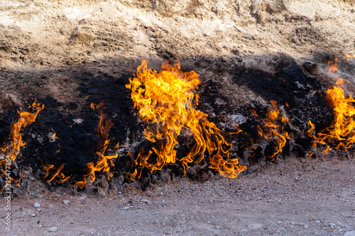 Nature burning ground. Burning natural gas