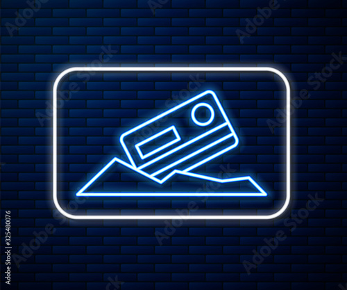Glowing neon line Cocaine and credit card icon isolated on brick wall background. Vector Illustration