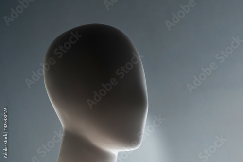 dark close-up of a plastic mannequin head