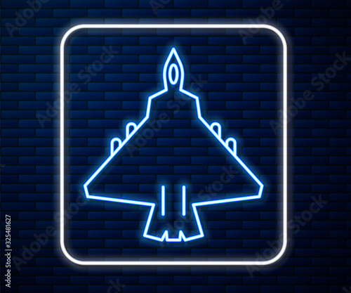 Glowing neon line Jet fighter icon isolated on brick wall background. Military aircraft. Vector Illustration