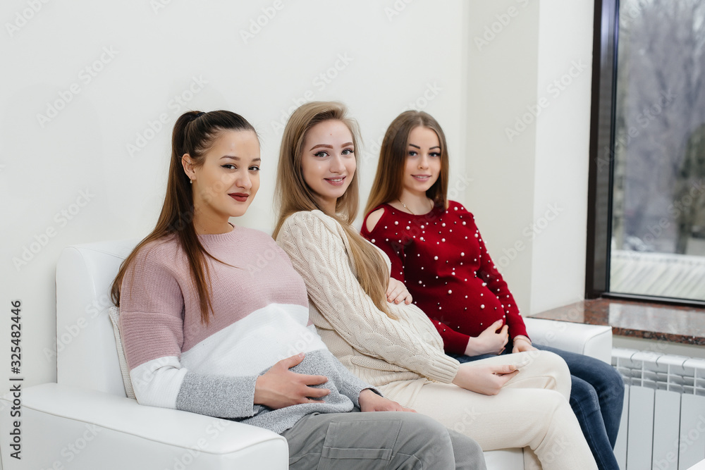 Pregnant girls are waiting for the doctor in the waiting room Pregnant girls are waiting for the doctor in the waiting room