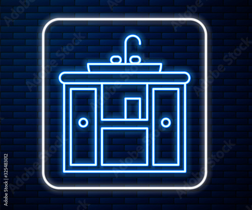 Glowing neon line Washbasin cabinet with water tap icon isolated on brick wall background. Vector Illustration