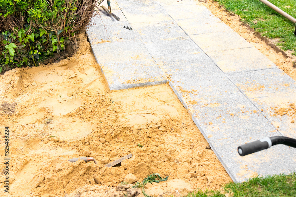 laying of gravel slabs on sand to make an alley Stock Photo Adobe Stock