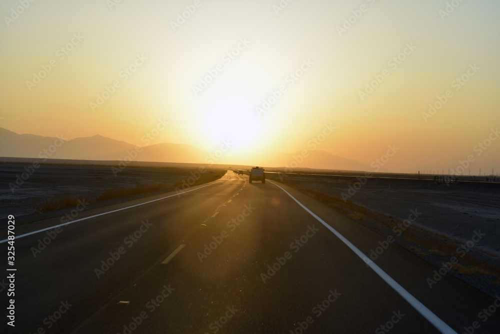 Naklejka premium driving on highway at sunset
