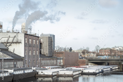 Factory at river with ships standing by © Florian Graf