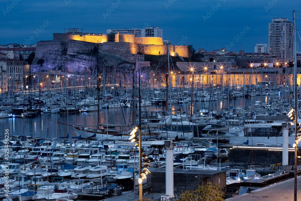 Night Old Port and fort Saint Nicolas on the background, on the hill, Marseille, France