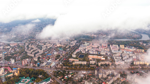 City through the clouds. Aerial view of autumn lanscape
