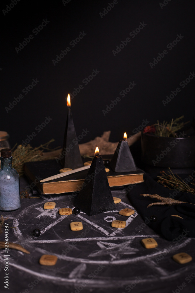 Fototapeta premium Black magic ritual with candles and runes