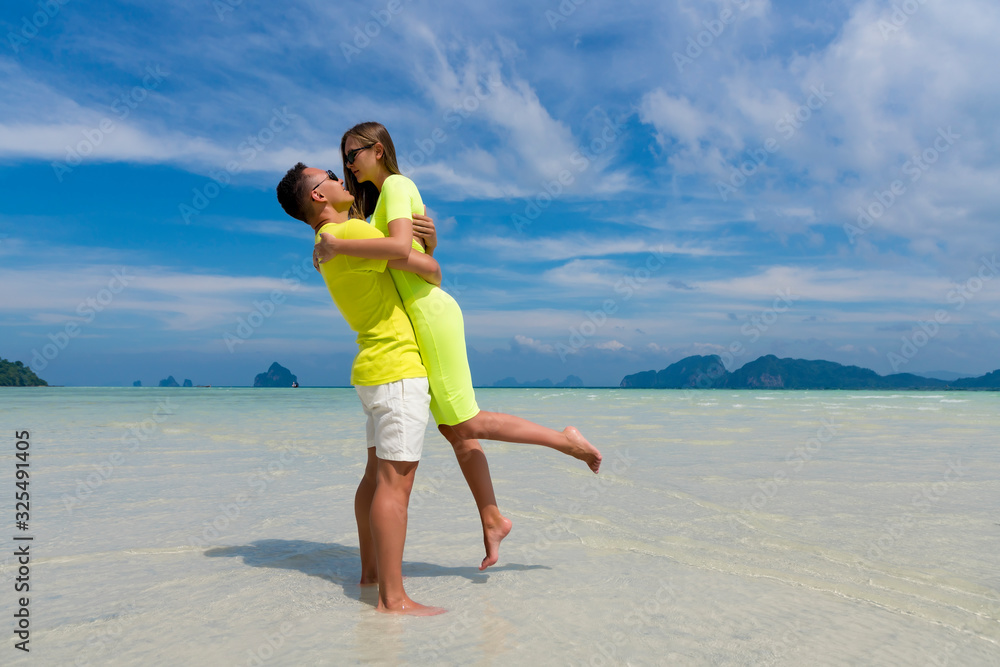 Happy couple in love on beach summer vacations. Joyful girl piggybacking on young boyfriend having fun. Happy couple in love on beach summer vacations. Joyful girl piggybacking on young boyfriend having fun.