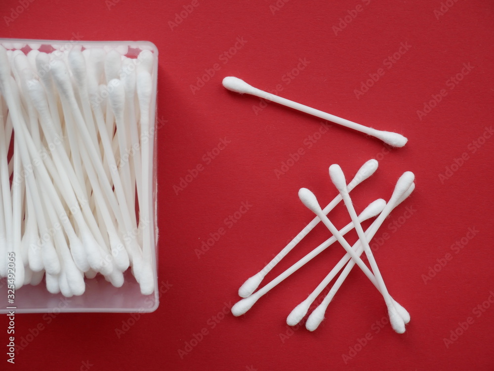 Flat lay composition with cotton swabs on red background. Flat lay composition with cotton swabs on red background.