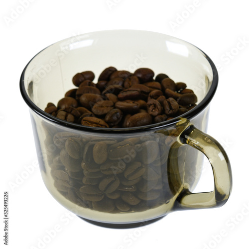 Dark roasted coffee beans in glass cup