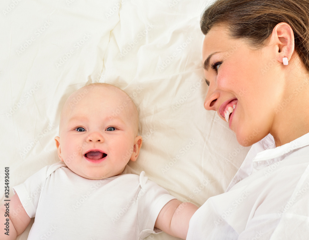 Mother and baby playing and smiling. Happy family. Mother and baby playing and smiling. Happy family.
