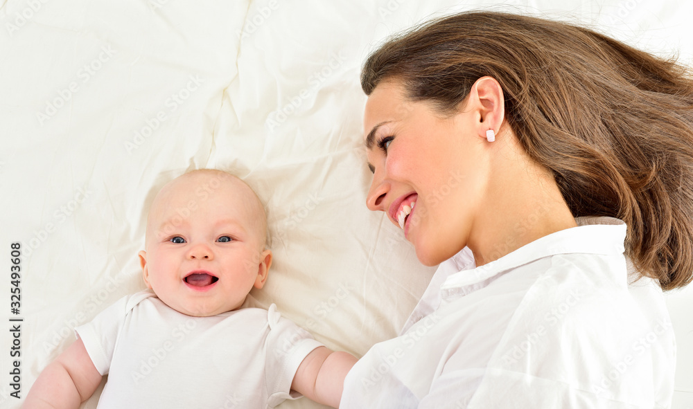 Mother and baby playing and smiling. Happy family. Mother and baby playing and smiling. Happy family.