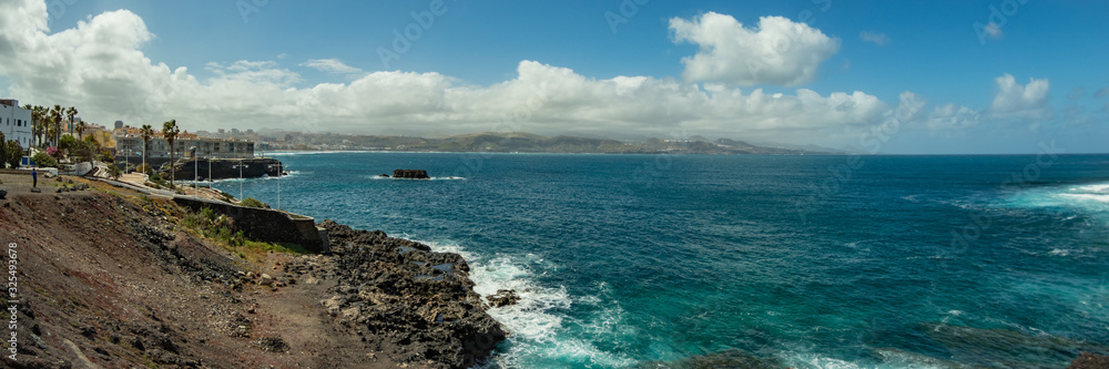 Extra large panorama from La Isleta an warm sunny day with briht blue sky and white clouds. Las Palmas, Las Canteras beach, Gran Canaria Extra large panorama from La Isleta an warm sunny day with briht blue sky and white clouds. Las Palmas, Las Canteras beach, Gran Canaria