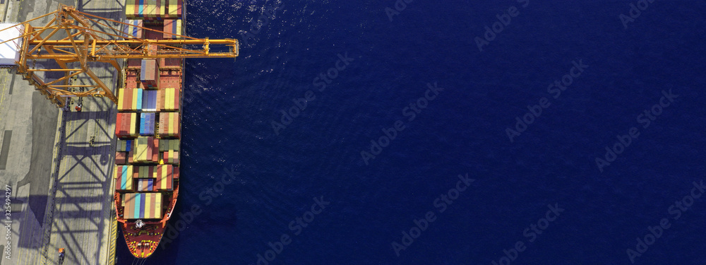 Aerial drone top down ultra wide photo of industrial container logistics loading - unloading ship terminal in Asian destination port Aerial drone top down ultra wide photo of industrial container logistics loading - unloading ship terminal in Asian destination port